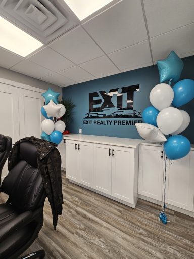 Office interior featuring a blue and white balloon decoration and an "EXT" sign on the wall.